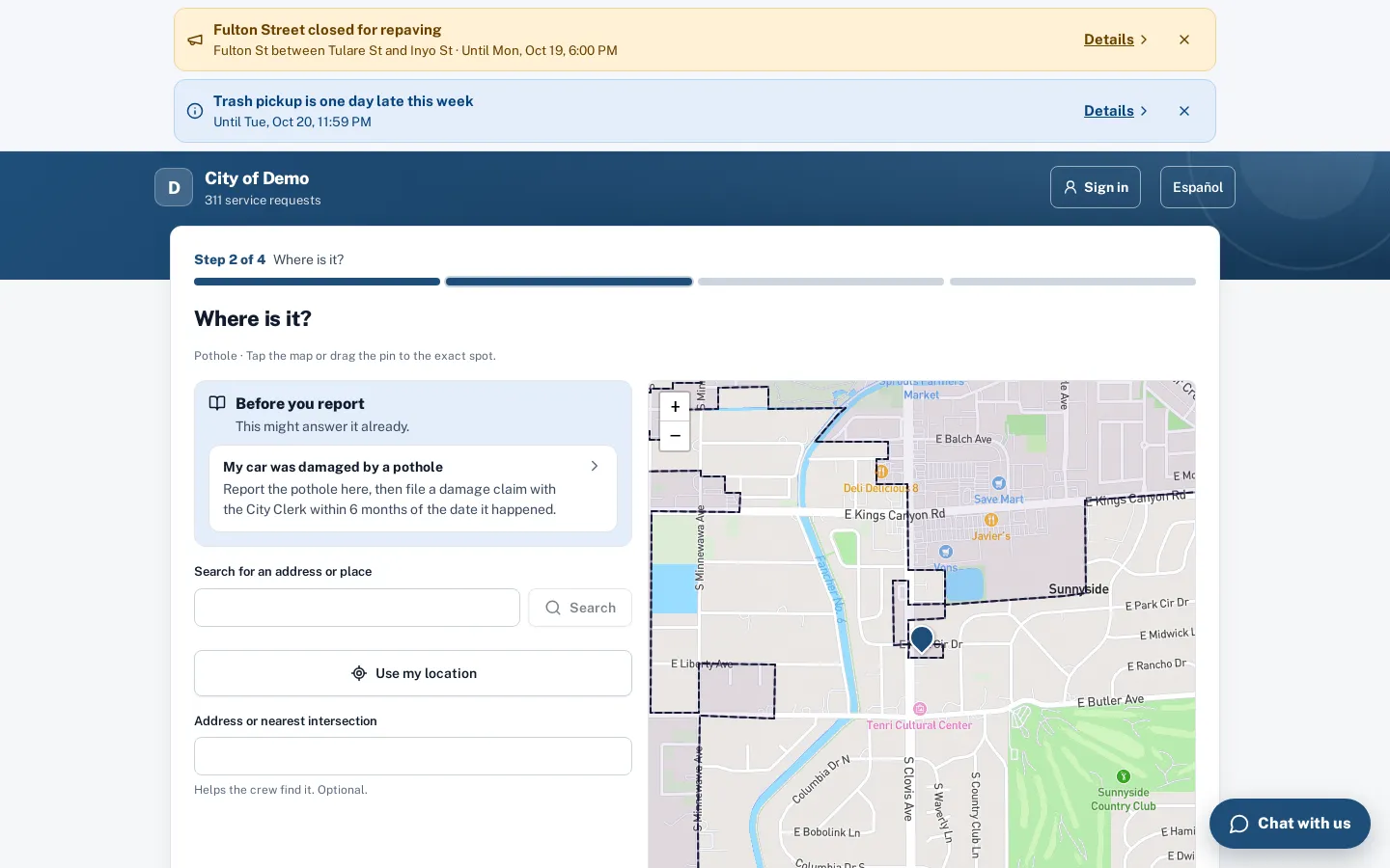 The report form’s location step: help answers and address search beside a map with council districts.